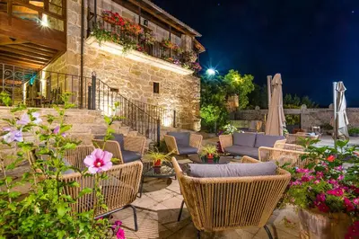 a patio with chairs and flowers and a building at Pazo de Esposende in Esposende