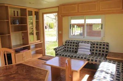 a living room with a couch and a table at Camping Fragadeume in Monfero