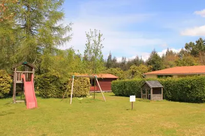 a yard with a swing set and a playground at Camping Fragadeume in Monfero