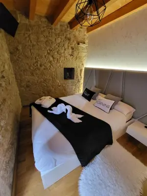 a bedroom with a bed in a stone wall at Casa Maral in Pontevedra