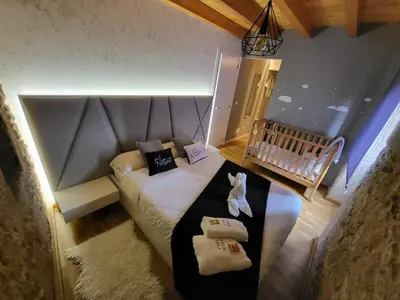 a small bedroom with a bed and a baby crib at Casa Maral in Pontevedra