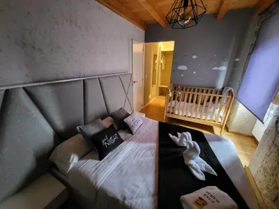 a small bedroom with a bed with a baby crib at Casa Maral in Pontevedra