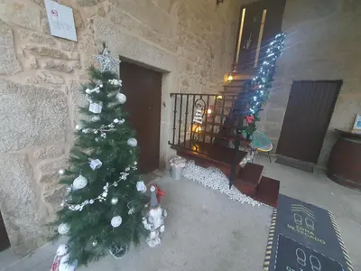 a christmas tree in a room with a staircase at Casa Maral in Pontevedra