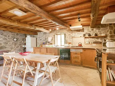 a kitchen with a wooden table and chairs at Holiday Home in Castrotañe near Sil Cañon in Castillón