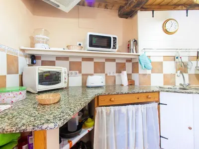 a kitchen with a counter top with a microwave at Holiday Home in Castrotañe near Sil Cañon in Castillón