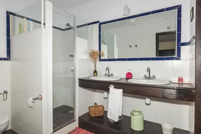 a bathroom with two sinks and a shower at Casona Las Burillas in Villar de los Barrios