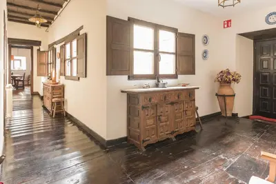 a kitchen with wooden cabinets and a sink in a room at Casona Las Burillas in Villar de los Barrios