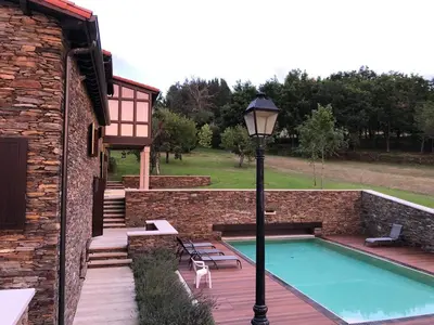 a pool with a light pole next to a building at Casa Pro Pantea in Monforte de Lemos