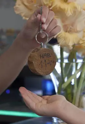 a person holding a key chain that says take my hand at Albergue Turistico Salceda in Salceda