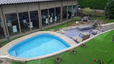 a large swimming pool in front of a building at Albergue Turistico Salceda in Salceda