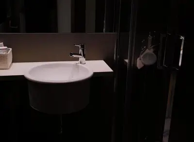 a bathroom with a white sink and a mirror at Hotel Zarampallo in Ourense