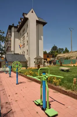 a playground in a park in front of a building at Hotel Gran Casona de Sanabria in Puebla de Sanabria