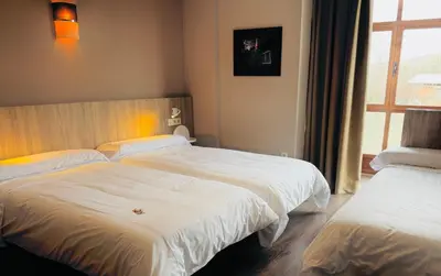 a hotel room with two beds and a window at Hotel Gran Casona de Sanabria in Puebla de Sanabria