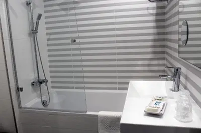 a bathroom with a shower and a sink at Hotel Altiana in Ourense