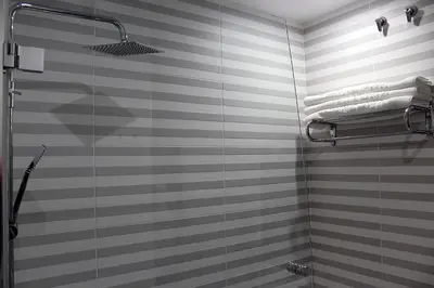 a bathroom with a shower with a glass door at Hotel Altiana in Ourense
