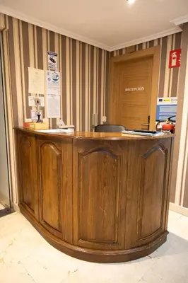 a wooden counter in a room with a door at Hotel El Molinón in Cangas del Narcea