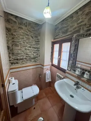 a small bathroom with a toilet and a sink at Casa Alberto in Castro Caldelas
