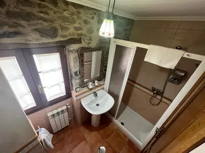 a bedroom with a bed and a window at Casa Alberto in Castro Caldelas