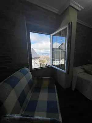 a bedroom with a bed and a large window at Casa Alberto in Castro Caldelas