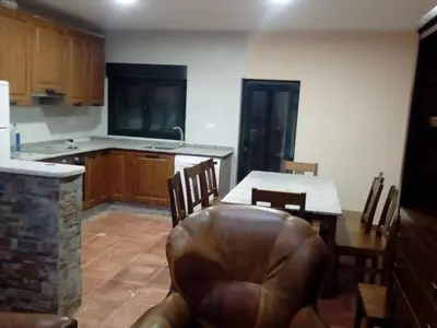 a kitchen and dining room with a table and chairs at Casa Rosi. Cumbres borrascosas Brañuelas in Villagatón