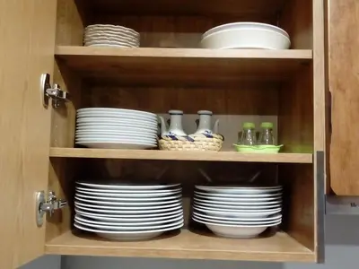 a cupboard with plates and dishes in it at Casa Rosi. Cumbres borrascosas Brañuelas in Villagatón