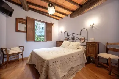 a bedroom with a bed and a table and chairs at Casa dos Ulloa in Esposende