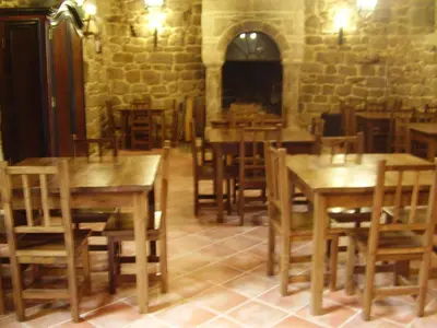 a dining room with wooden tables and chairs at Casa dos Ulloa in Esposende
