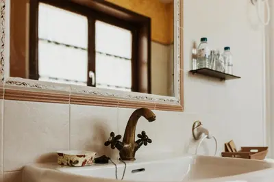 a bathroom with a sink and a mirror at Casa da Capilla in Gres