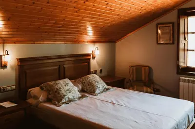a bedroom with a bed with two pillows on it at Casa da Capilla in Gres