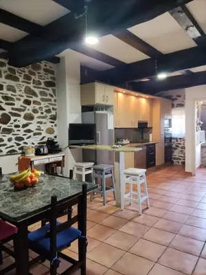 a large kitchen with a table and some chairs at Falagueira in Monforte de Lemos