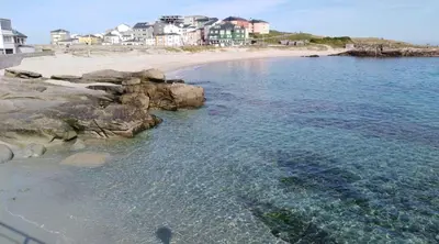 an aerial view of a beach with rocks and water at San Ciprian, belleza y tranquilidad. in San Ciprián