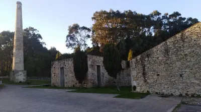 a stone wall with a monument in the background at San Ciprian, belleza y tranquilidad. in San Ciprián