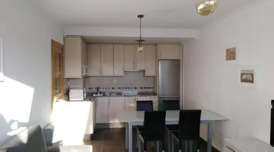 an empty kitchen with a table and chairs at San Ciprian, belleza y tranquilidad. in San Ciprián