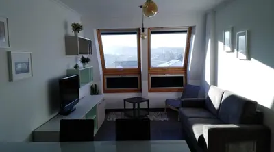 a living room with a couch and a tv at San Ciprian, belleza y tranquilidad. in San Ciprián