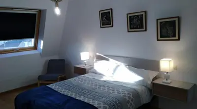 a bedroom with a bed and two lamps and a window at San Ciprian, belleza y tranquilidad. in San Ciprián