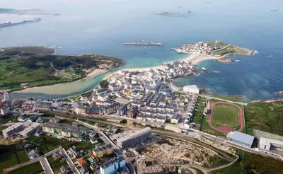 an aerial view of a city and the ocean at San Cibrao,belleza y tranquilidad. in San Ciprián