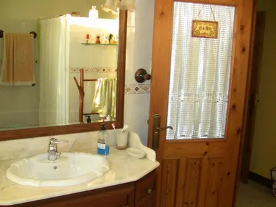 a bathroom with a sink and a mirror at Casa Xan da Pena in Villarmayor