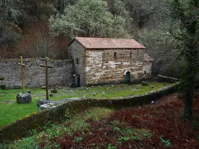 an old stone building with birds standing around it at Stone Cottage FISTERRA in Curtis
