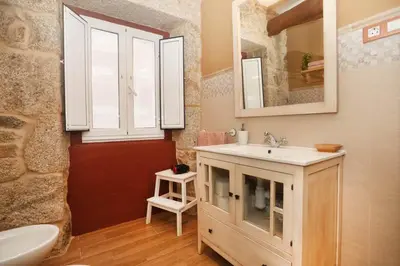 a bathroom with a sink and a mirror at A Casa do Avó in Palas de Rei