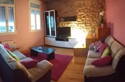 a living room with two couches and a tv at A Casa do Avó in Palas de Rei