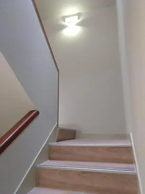 a staircase with a light on the top of it at Travesia Rooms in Sarria