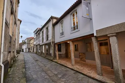 an empty street in an old town with buildings at Albergue San Francisco in Arzúa
