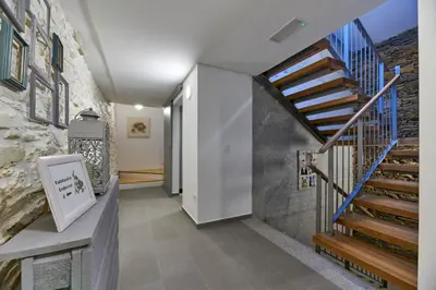 a hallway with a staircase in a house at Albergue San Francisco in Arzúa