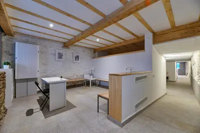 a kitchen with a counter and a table in a room at Albergue San Francisco in Arzúa