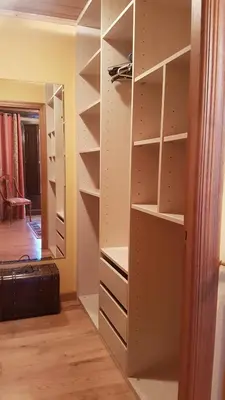 a closet with white shelves and a mirror at Casa Santiago in Currelos