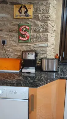 a kitchen with a stove and a counter top at Casa Santiago in Currelos