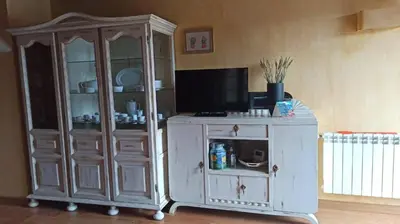 a white cabinet with a television on top of it at Casa Santiago in Currelos