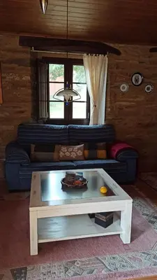 a living room with a blue couch and a coffee table at Casa Santiago in Currelos