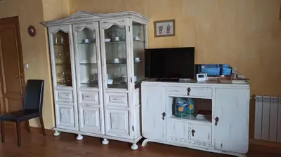a white cabinet with a tv in a room at Casa Santiago in Currelos