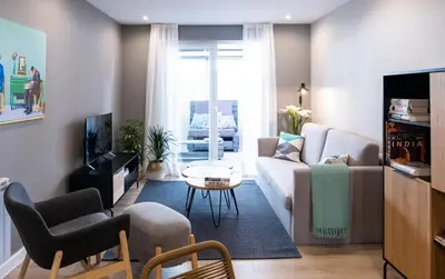 a living room with a couch and a table at Apartamento de diseño centrico con terraza espectacular in Santiago de Compostela